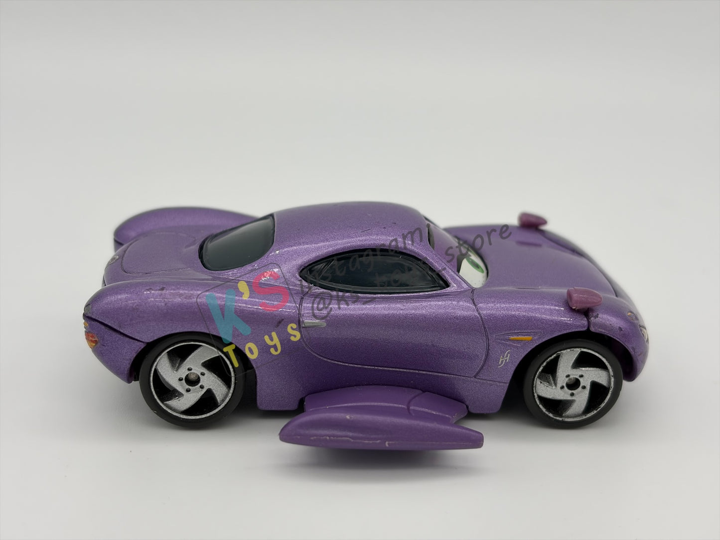 PRE-OWNED / LOOSE DELUXE DISNEY PIXAR CARS BY MATTEL - "HOLLEY SHIFTWELL WITH WINGS" CARS 2 PALACE CHAOS SERIES - GOOD CONDITION