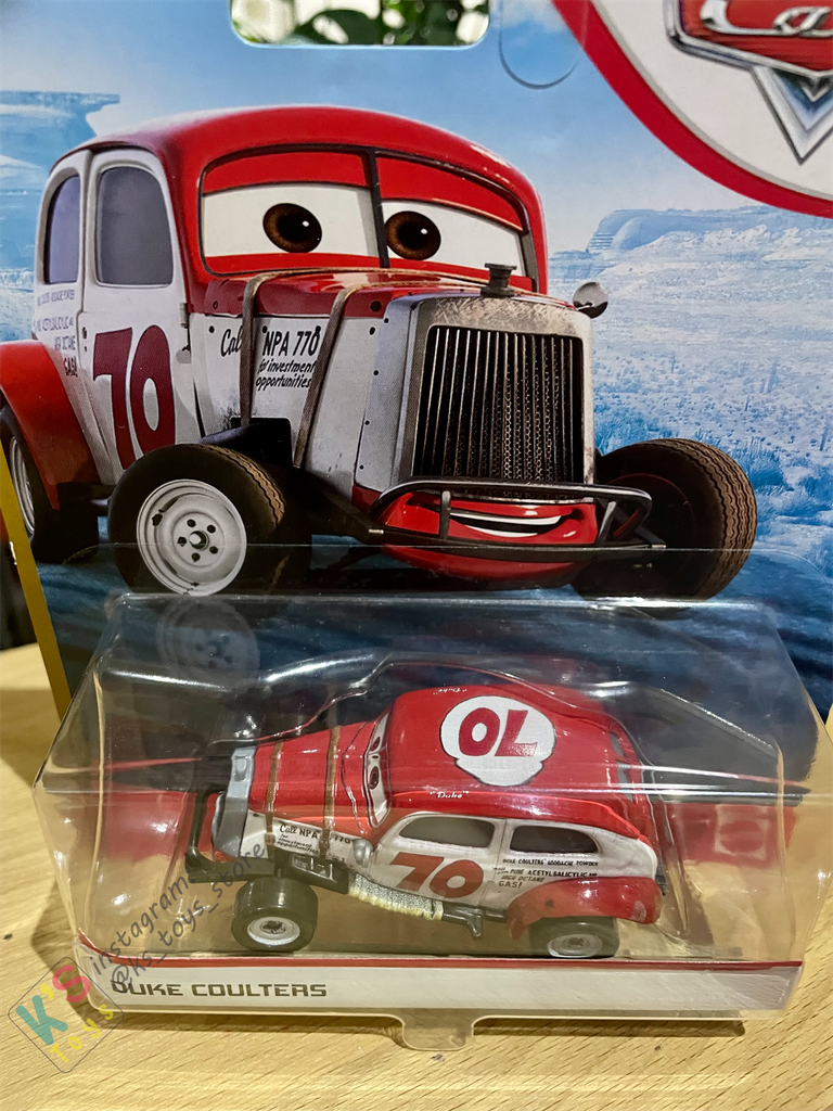 DISNEY PIXAR CARS "DUKE COULTERS" DOC'S RACING - BNIP